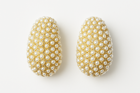Pearl studded earrings on white background